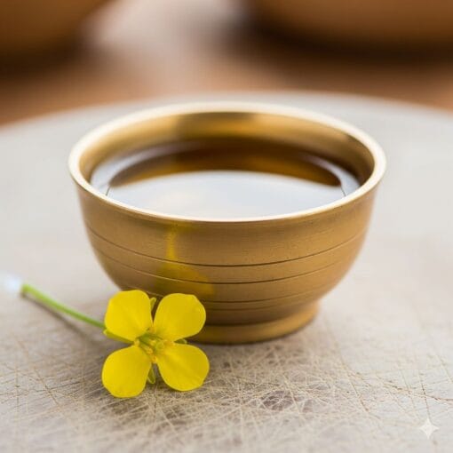 A Brass Katori Filled With Kathait Gold Mustard Oil, Ready For Use As A Therapeutic Hair Oil Or For A Body Massage, Promoting Wellness.
