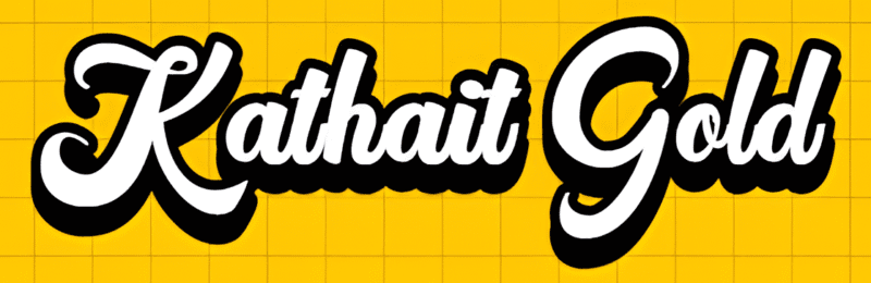 Kathait Gold In A Bold, Stylized White Script With A Thick Black Outline On A Bright Yellow Grid Background.