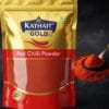 Kathait Gold Red Chilli Powder in its golden and red pouch, with a spoonful of the vibrant red spice powder on the side.