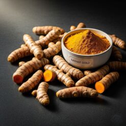 Fresh, Raw Turmeric Roots Arranged On A Dark Slate Background Next To A Small Bowl Of Fine Kathait Gold Turmeric Powder, Showing The Natural Journey From Root To Spice.