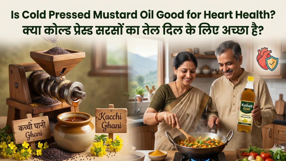 A Featured Image Titled &Quot;Is Cold Pressed Mustard Oil Good For Heart Health?&Quot; In English And Hindi, Showcasing A Traditional Wooden Kacchi Ghani Oil Press And An Indian Couple Cooking With Kathait Gold Branded Cold-Pressed Mustard Oil In A Kitchen.